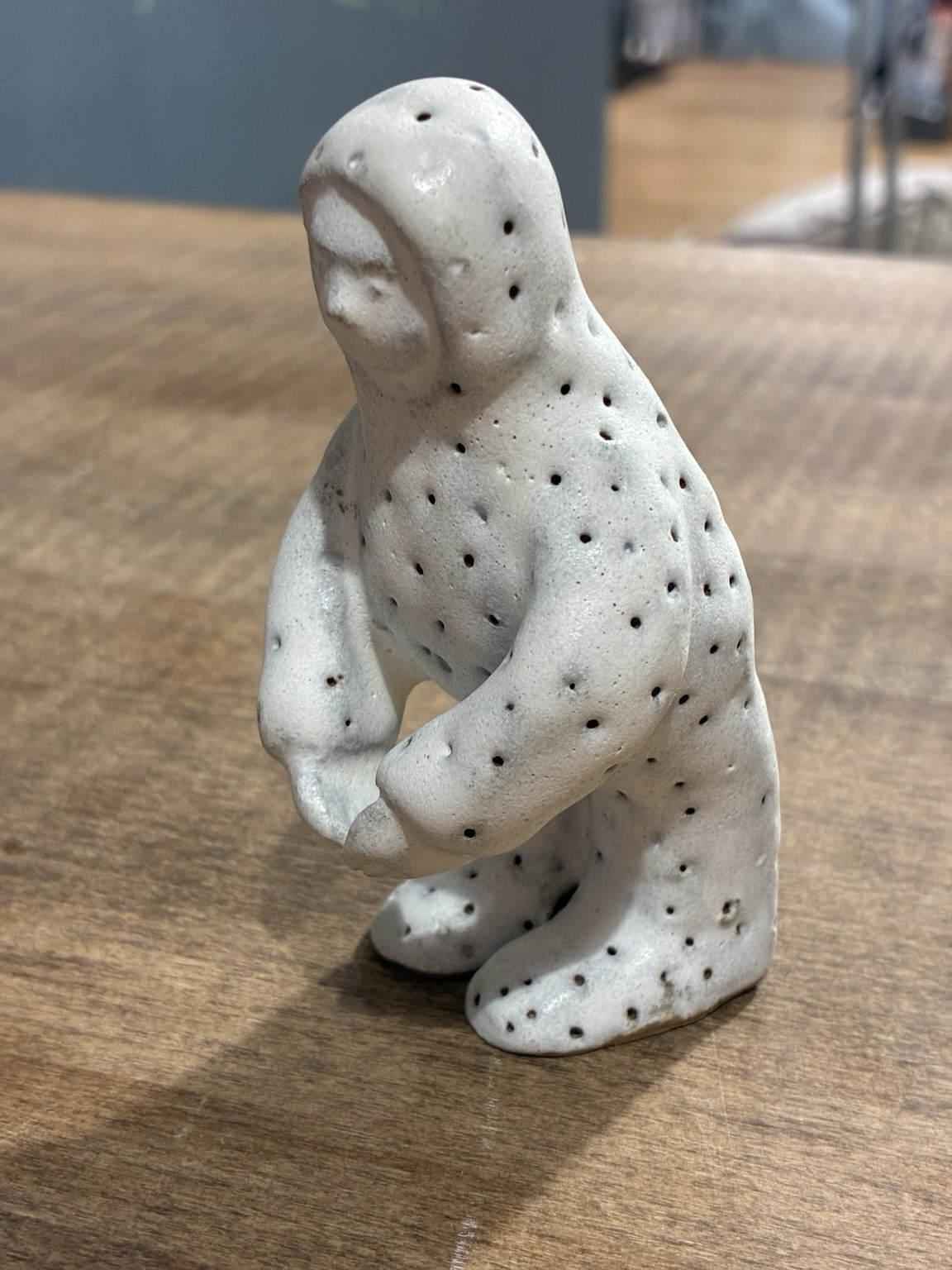 A mushroom man with his fingertips touched together. The Left side.
