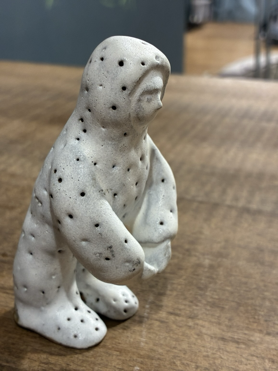 A mushroom man with his fingertips touched together. The Right side.
